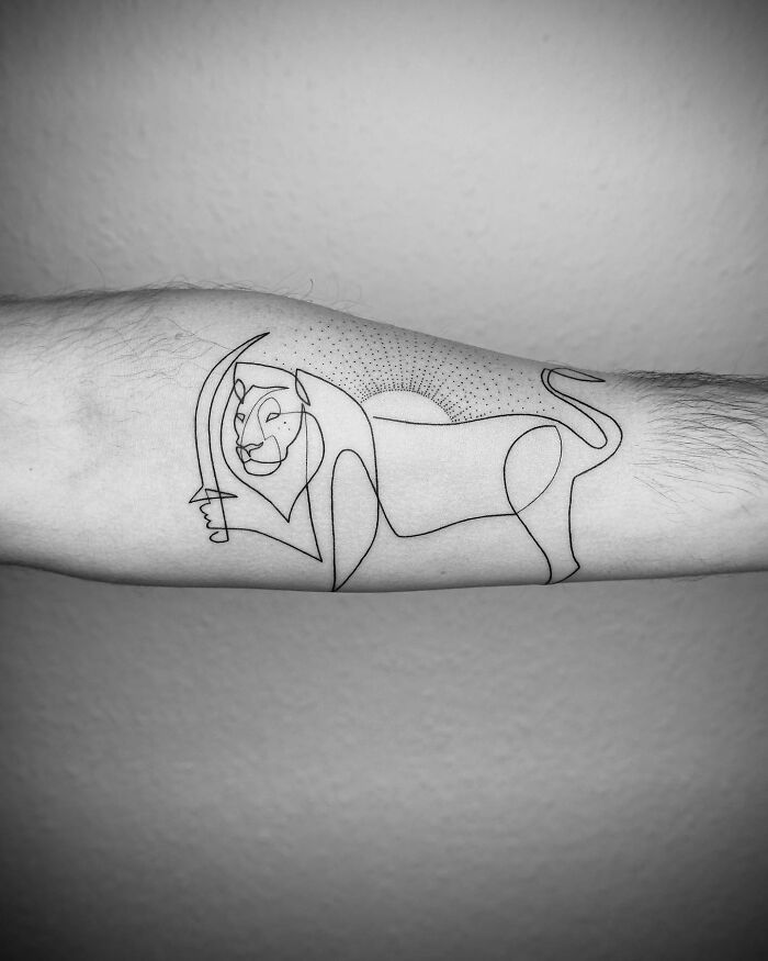 Single line tattoo of a lion on an arm, showcasing minimalist and captivating artwork.