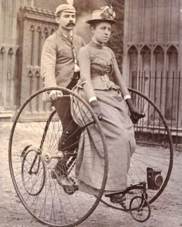 Young Victorian couple on a tricycle, 1880s.