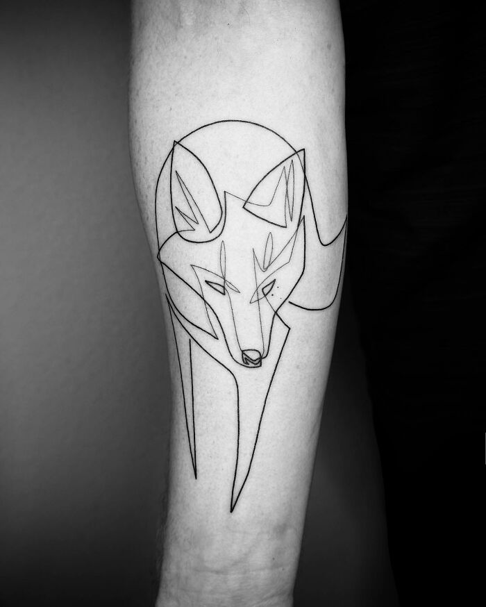 Single line tattoo of a stylized fox on a forearm, showcasing captivating tattoo artistry.