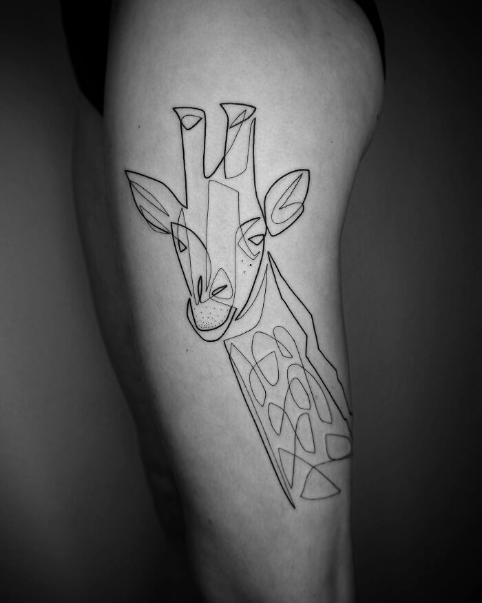 Single line tattoo of a giraffe on skin, showcasing captivating minimalist art.