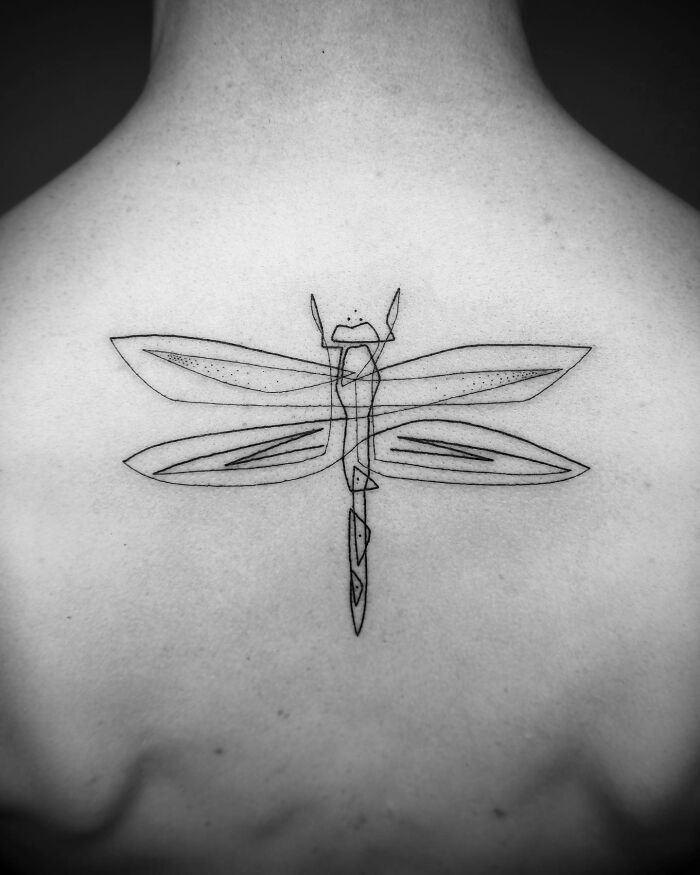 Single line dragonfly tattoo on a person's back, showcasing captivating minimalist art.