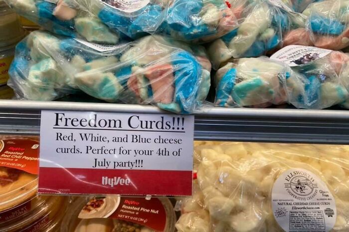 Red, white, and blue cheese curds packaged and displayed in a supermarket, labeled as "Freedom Curds."