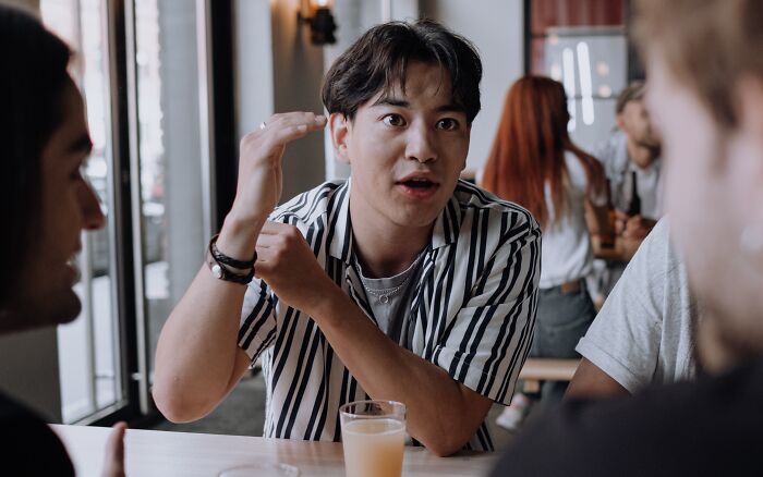 A man wearing white shirt with black stripes 