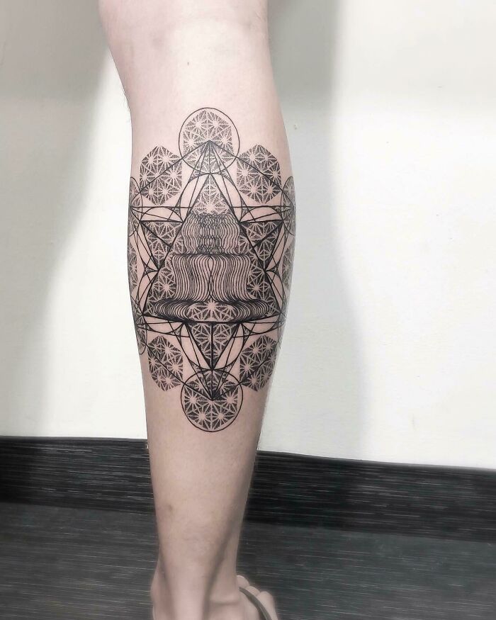 Leg tattoo with intricate optical illusion design featuring geometric patterns and eye-bending details.