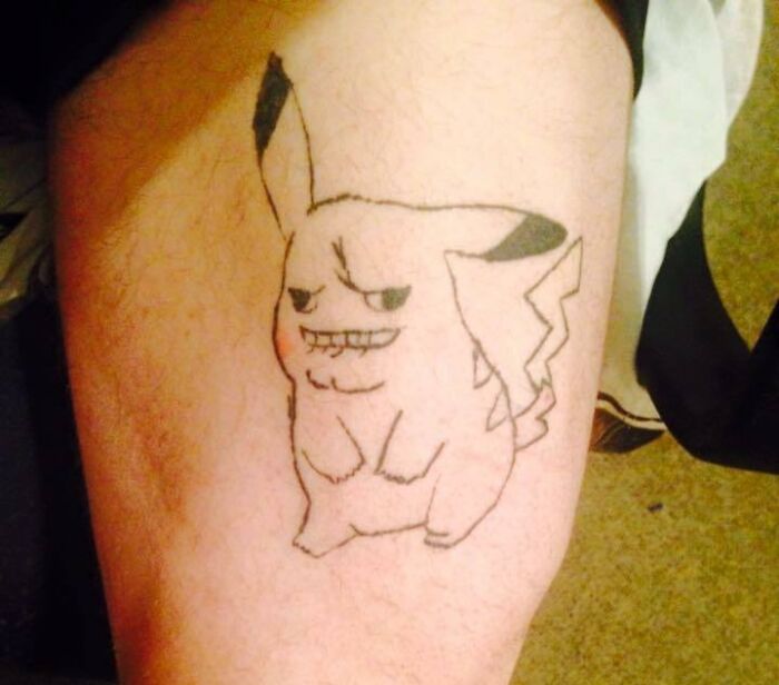 Tattoo fail of a poorly drawn Pikachu with an awkward expression on a person's leg, showcasing an epic tattoo fail.