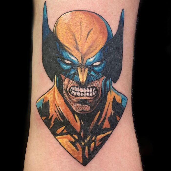 Wolverine tattoo showcasing vibrant colors and fierce expression on forearm, a tribute to Marvel.