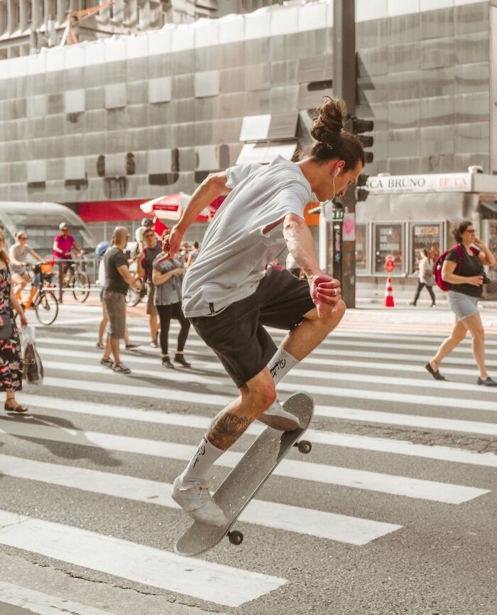 man skateboarding on the road