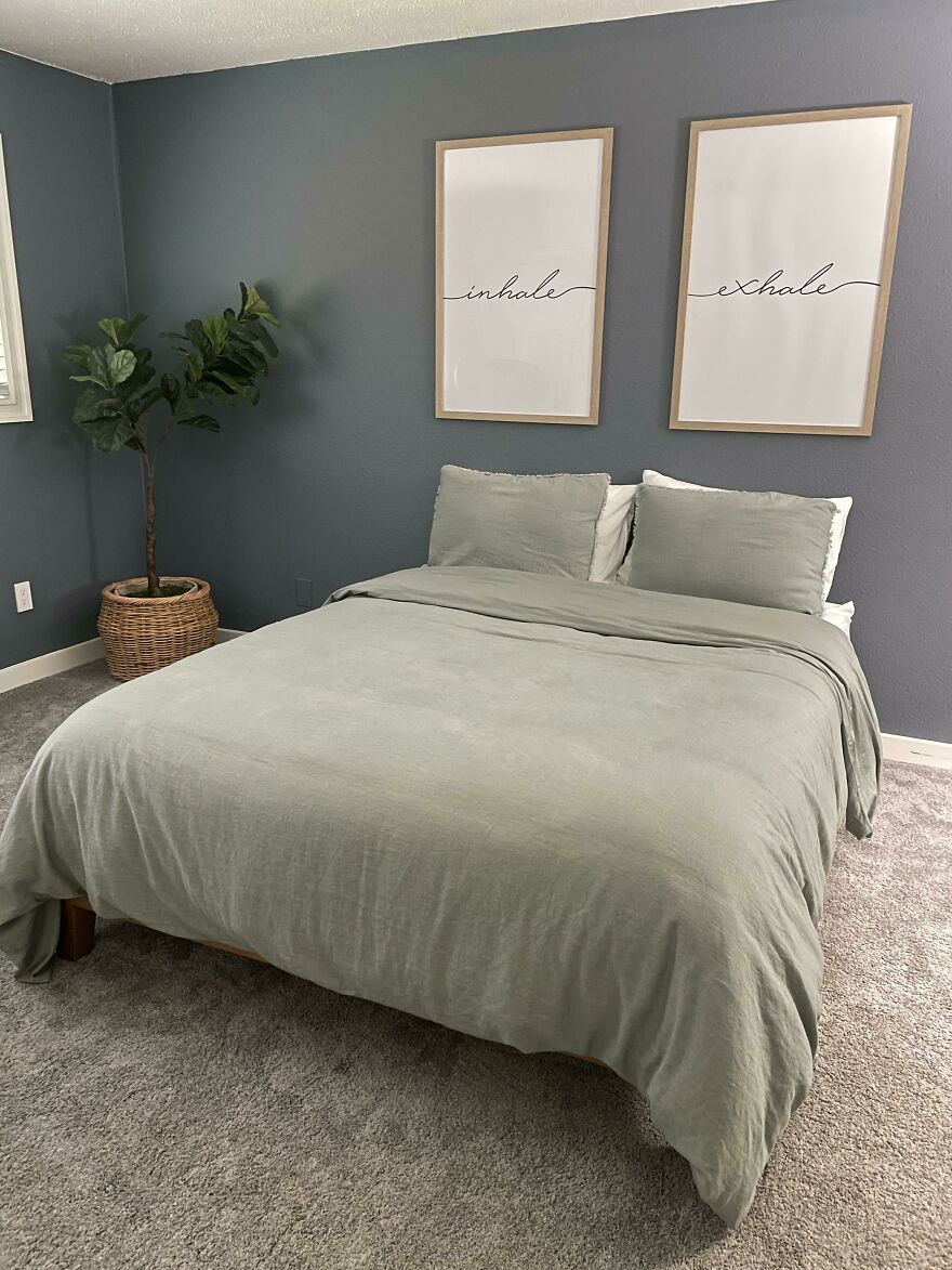 Grey bedroom with a plant in the corner 