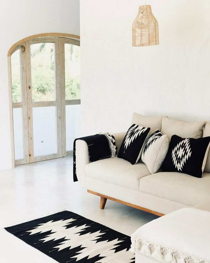 White couch with the black pillows 