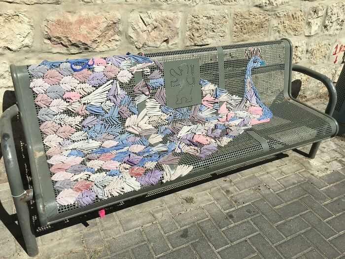Someone Took Advantage Of The Pattern Of Holes In This Bus Stop Bench To Macrame A Peacock Into It