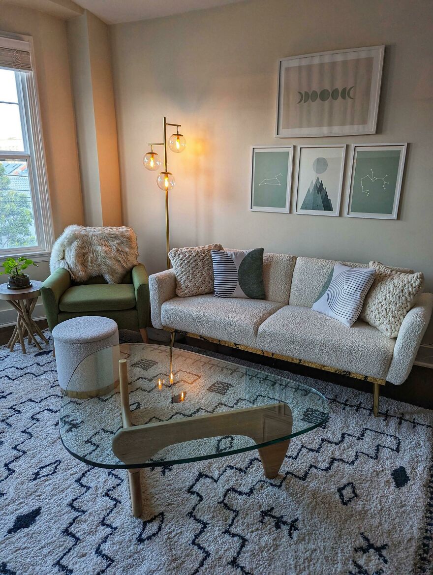 White couch next to a green chair 