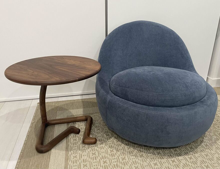 Blue chair next to a wooden table 