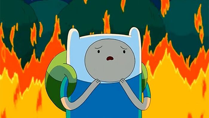 Finn the Human from Adventure Time surrounded by flames, showcasing a wacky yet profound moment in the series.
