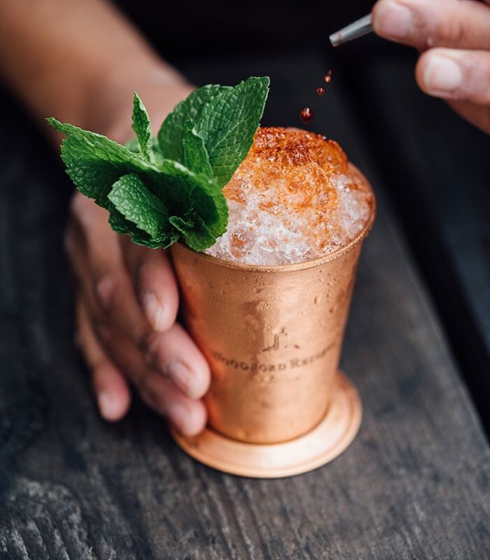 Brass cup of crushed ice with mint, a fun hobby cocktail creation.