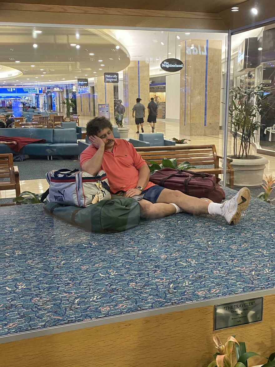 Man trying to rest with his luggage in an airport 