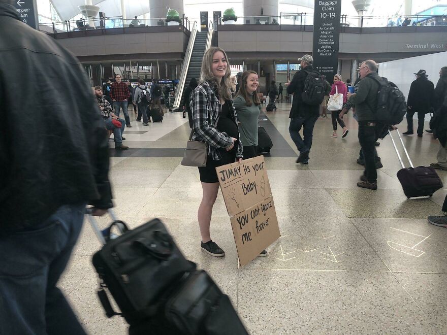 Woman holding an Embarrassing welcoming sign 