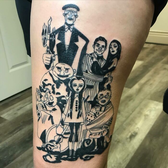 Family tattoo of cartoon characters symbolizing unbreakable bonds on leg.