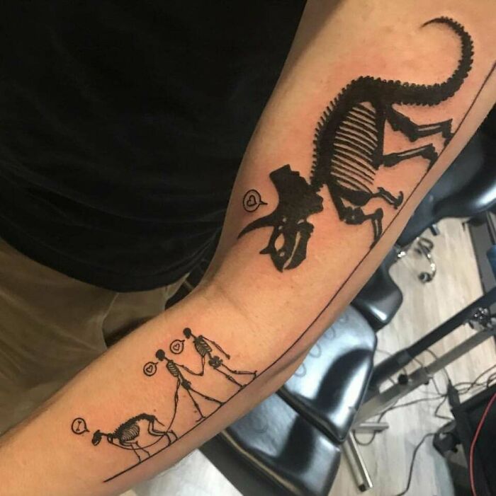 Dinosaur skeleton family tattoo symbolizing unbreakable bonds on a person's arm.