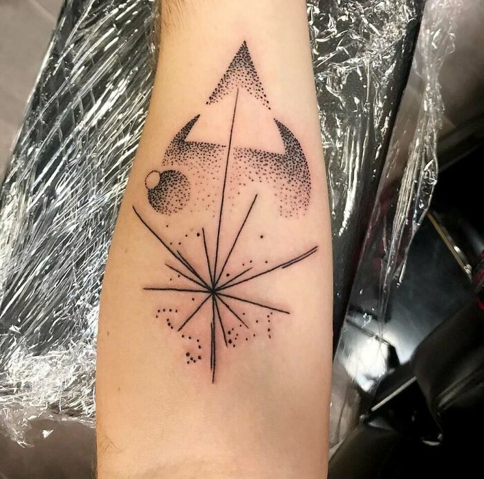 Geometric design tattoo on forearm symbolizing family bonds.