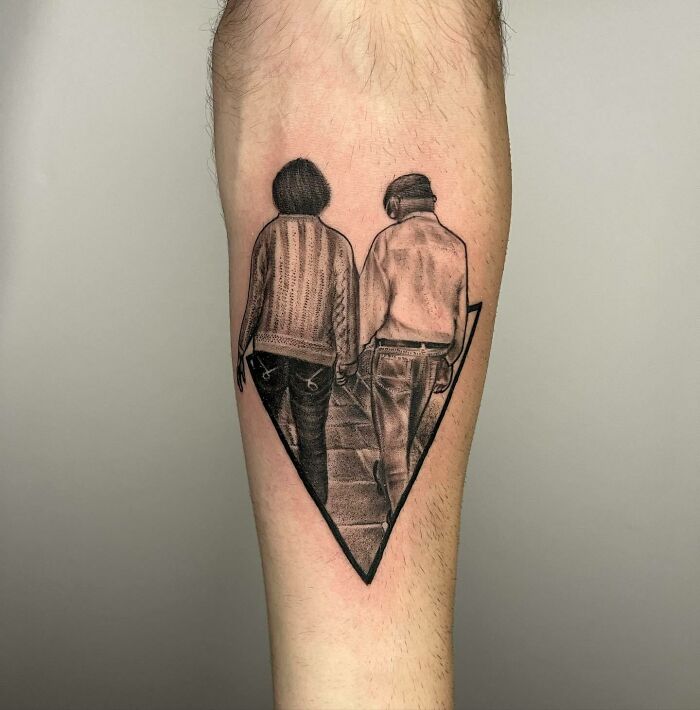 Family tattoo of two people walking, symbolizing unbreakable bonds, on forearm.