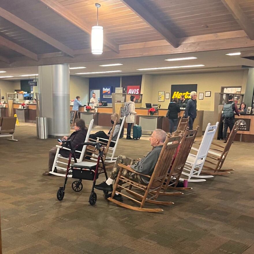 Multiple old people sitting in rocking chairs 