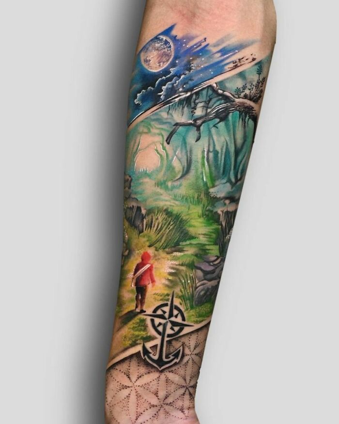 Nature tattoo featuring a forest path and moon on arm, highlighting earth's wonders.