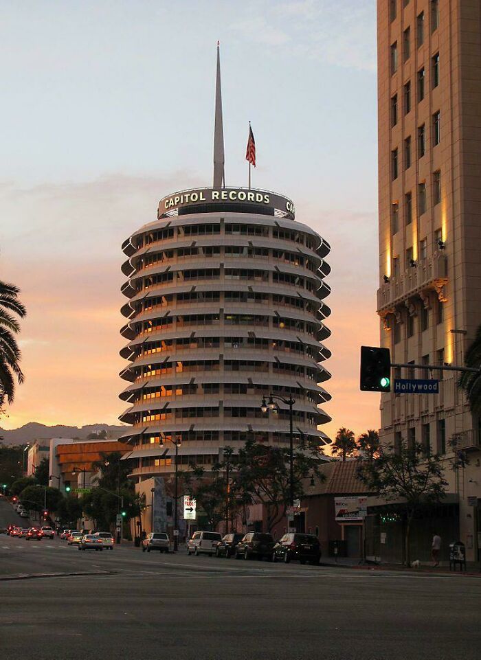 Capitol Records Building, Los Angeles, California. Designed By Welton Becket, The 13-Story Tower Resembles A Stack Of Records. When Completed In April 1956, It Was The World’s First Circular Office Building. The Blinking Light Atop The Tower Spells Out The Word "Hollywood" In Morse Code. [745x1023]