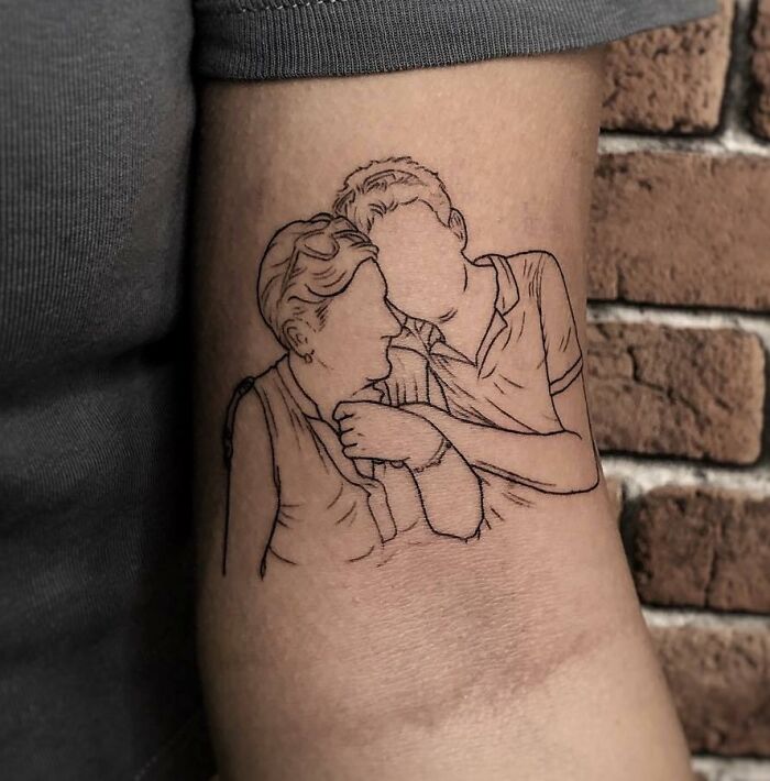 Mom tattoo idea depicting a mother and child embracing, symbolizing the bond and love in their relationship.