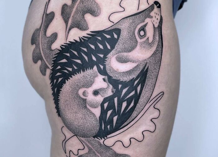 Mother-child bond tattoo featuring a hedgehog with her baby, surrounded by leaf patterns.