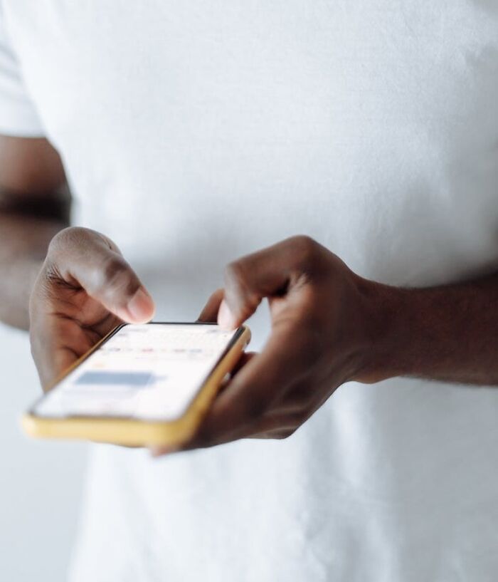 person writing something on his mobile phone