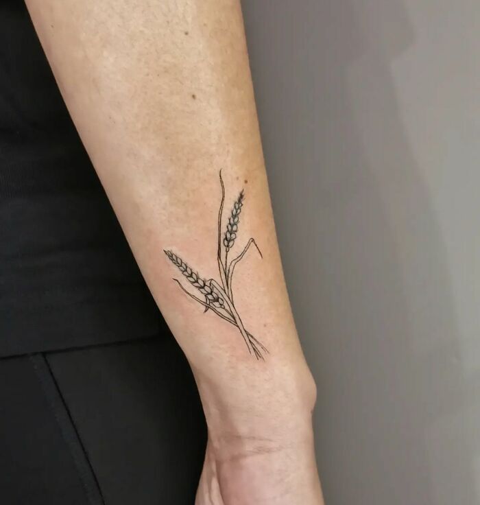 Minimalist wrist tattoo with floral design, exemplifying timeless accessory style.