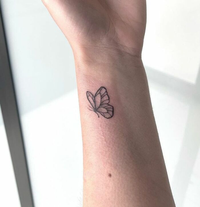 Butterfly wrist tattoo design showcasing elegant simplicity and timeless style.