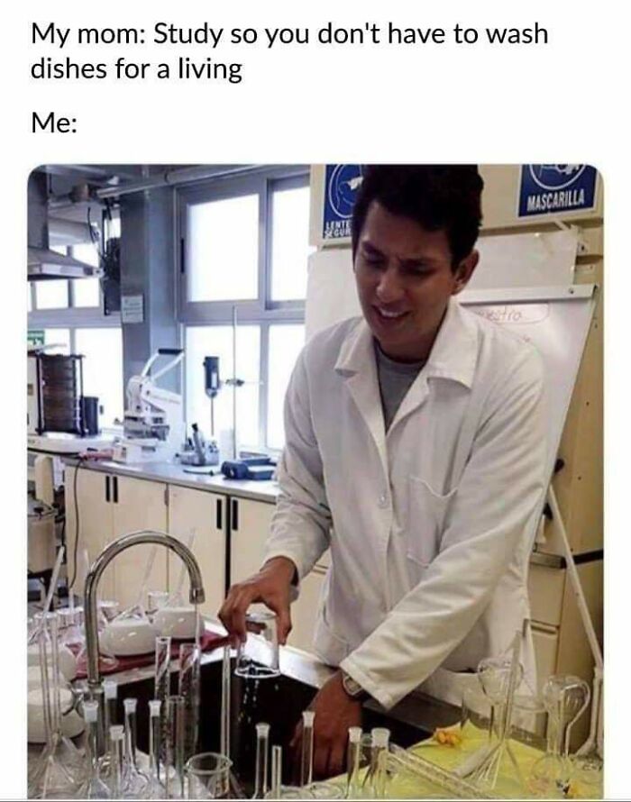 Young man in a science lab wearing a white coat washing glass beakers, illustrating science memes with humor and brains.