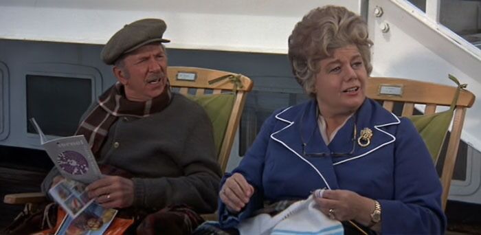 A couple sitting on the beach chair on the cruise liner 