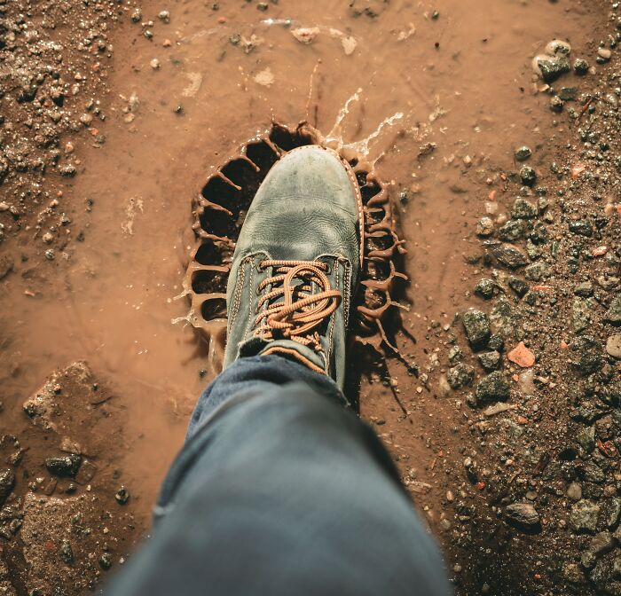 Person Walking Through The Mud Puddle 
