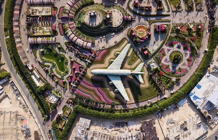 Aerial view of an airplane sculpture in a garden, illustrating flight attendants sharing passenger annoyances online.