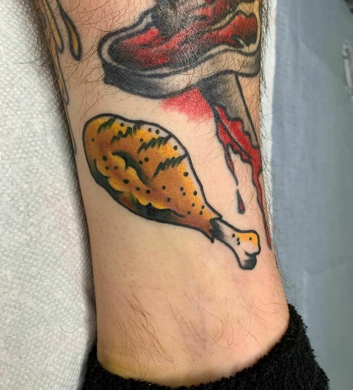 Watercolor tattoo of a fried chicken leg, showcasing one of the vibrant food tattoo ideas for enthusiasts.