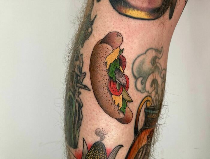 Watercolor hot dog tattoo on leg showcasing colorful food ink-spiration.