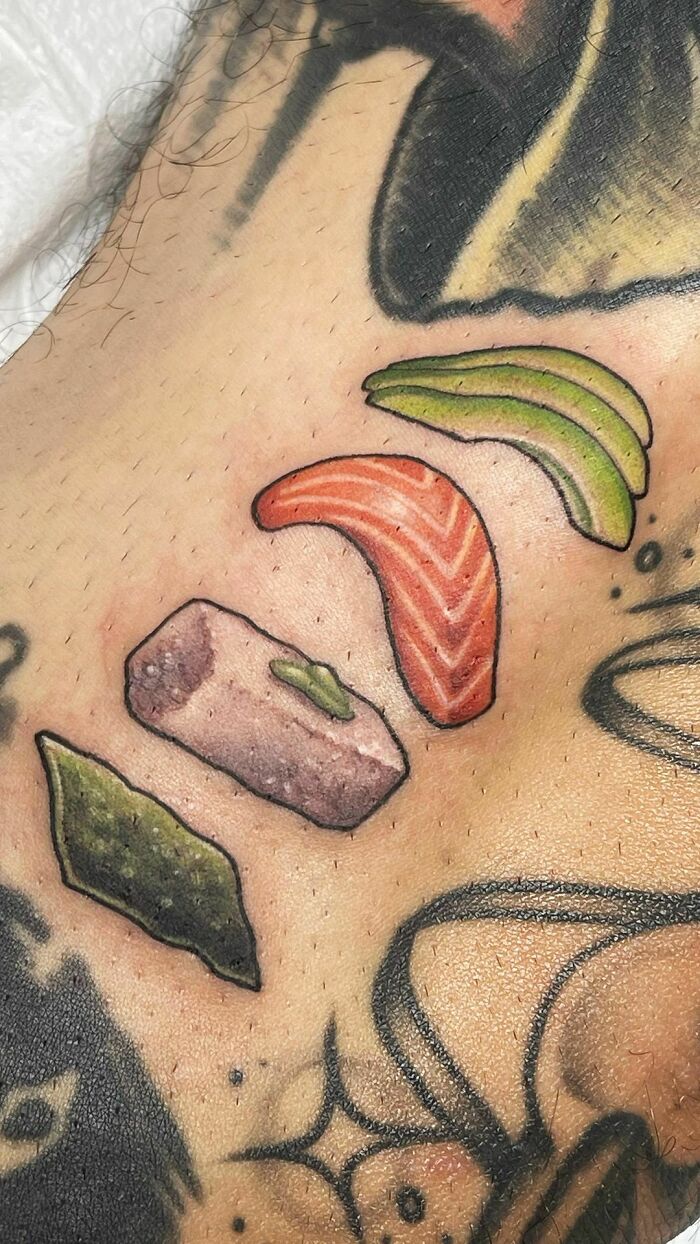 Food tattoos featuring sushi elements in vibrant colors on skin.