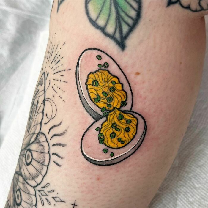 Watercolor tattoo of eggs with green onions, showcasing tasty ink-spiration in food tattoo art.