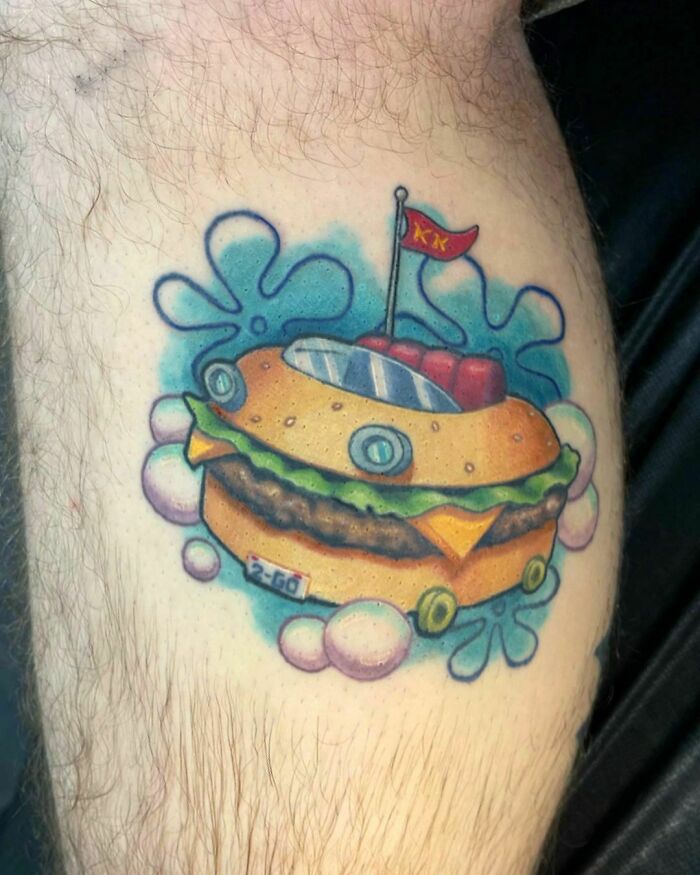 Watercolor tattoo of a SpongeBob SquarePants burger, showcasing vibrant food tattoo inspiration.