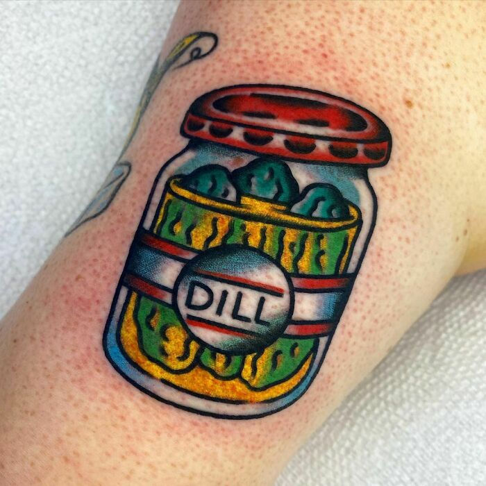 Watercolor tattoo of a pickle jar on skin, showcasing a unique food-inspired design.