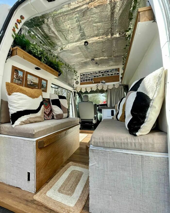 Interior of a stylish tiny house van with cozy seating and rustic decor.