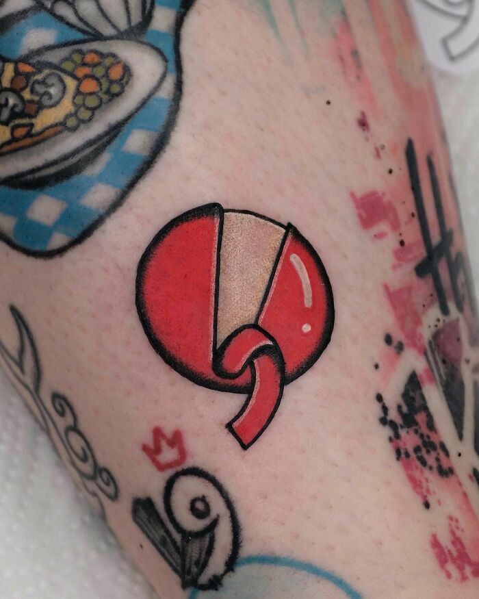 Food tattoo featuring a red lollipop design on skin, surrounded by vibrant, colorful elements.