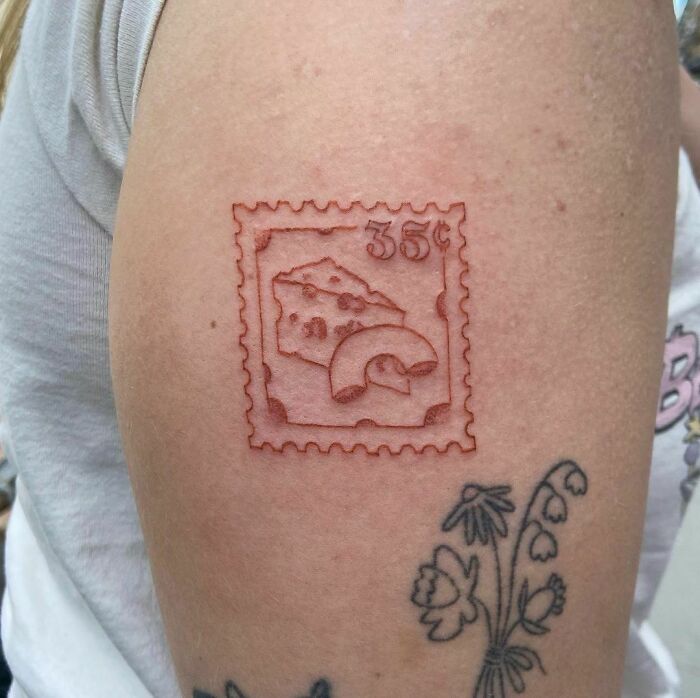 Food tattoo idea: Mac and cheese stamp design on arm showcases unique ink-spiration.