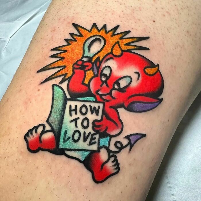 American traditional tattoo of a cute red devil holding a "How to Love" book on skin.