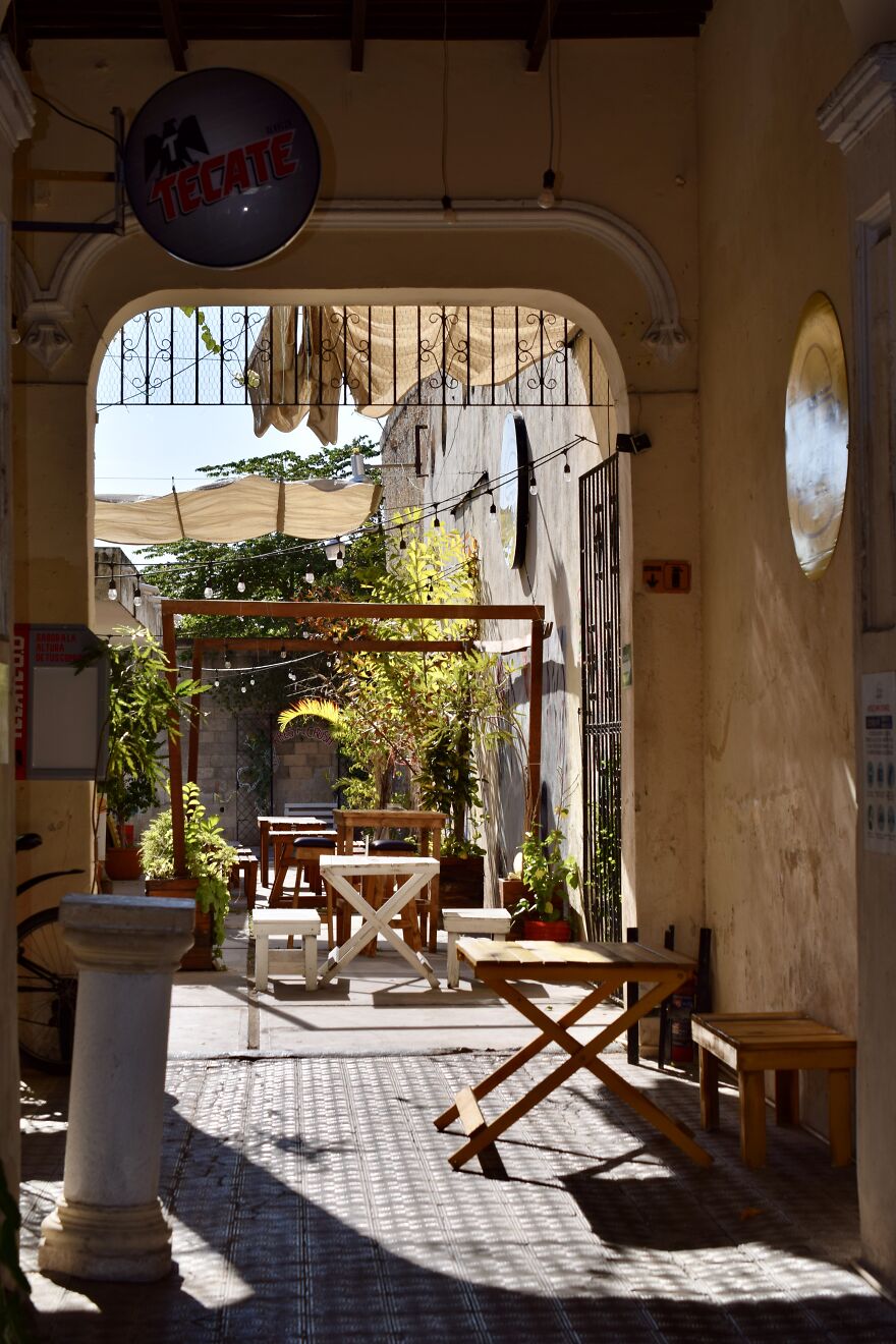 An Atrium With Tables And Chairs In Merida, Mexico