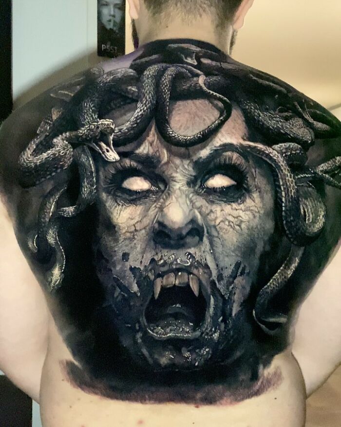 A highly detailed Medusa tattoo on a man's back, showcasing advanced tattoo art techniques.