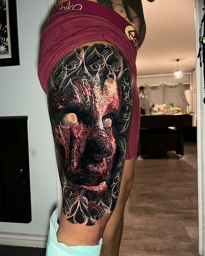 Intricate tattoo art covering a person's thigh, showcasing advanced and detailed design techniques.