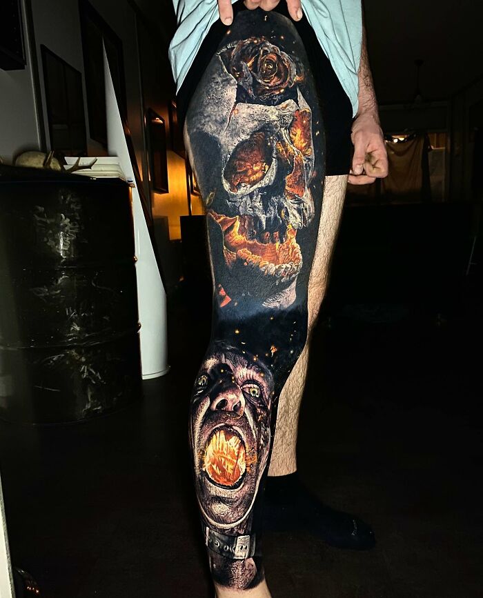Tattoo art featuring a realistic, fiery skull and screaming face on a person's leg, showcasing intricate details and colors.